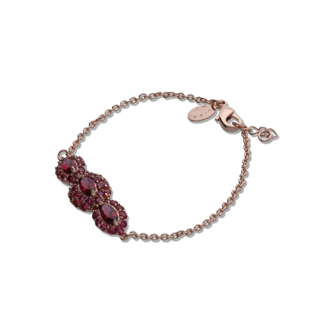 An eye bracelet in the form of a marquise inlaid with ruby colored crystal stones
