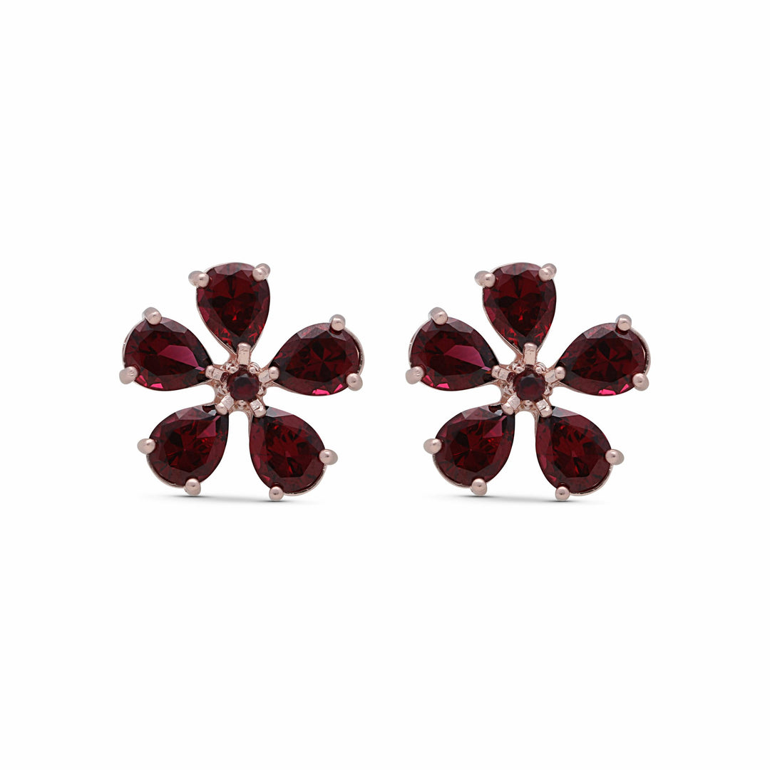 Stud earrings with a wish flower studded with ruby-colored crystal stones