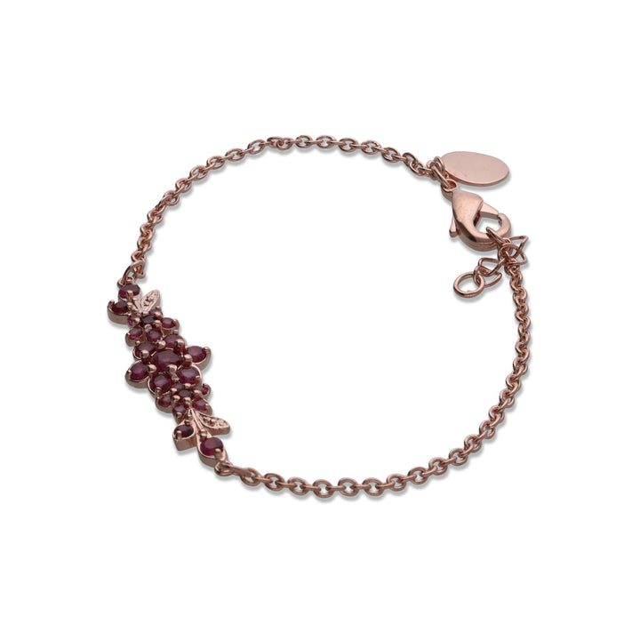 A medium flowering branch bracelet studded with ruby colored crystal stones
