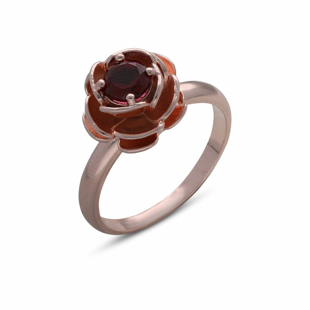 A rose ring studded with a ruby-colored crystal stone