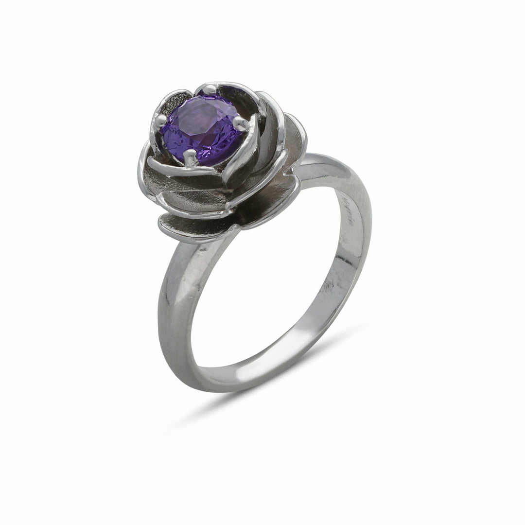 A rose ring set with a purple crystal stone