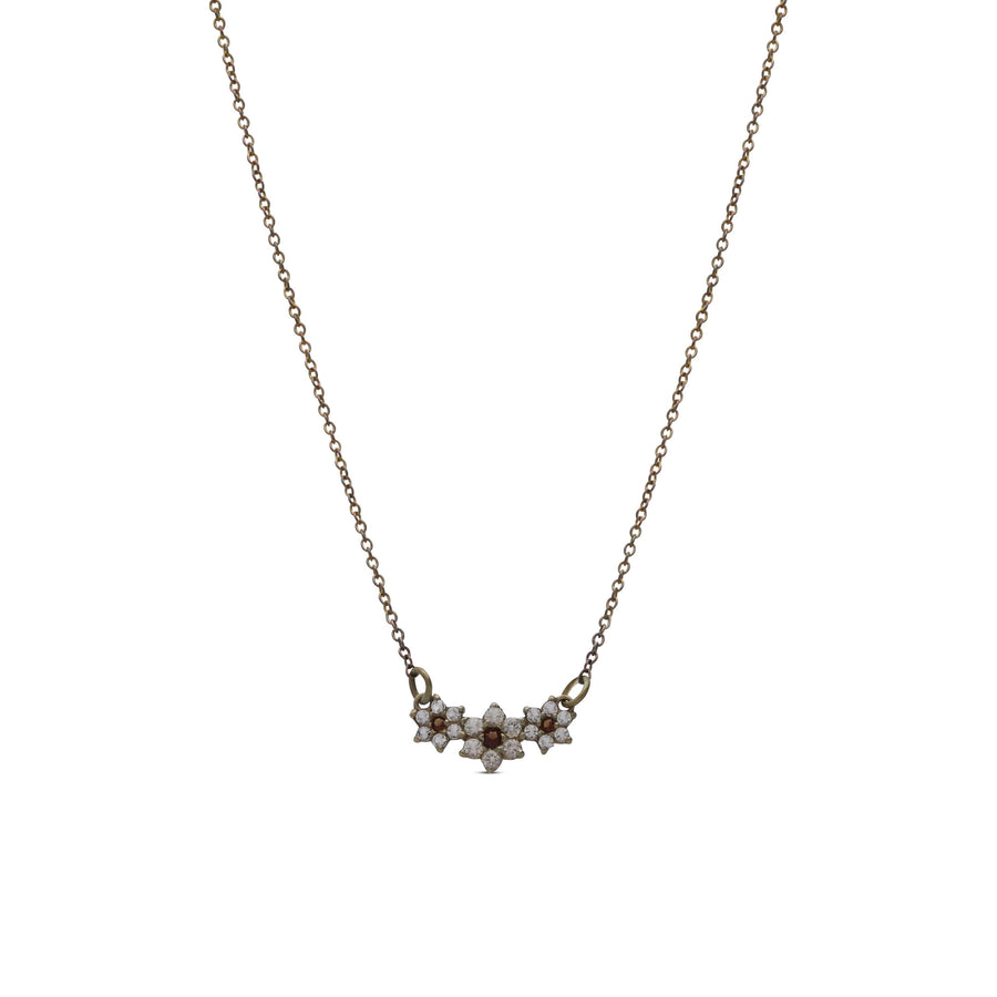 The necklace of the three flowers is studded with crystal stones in cream and garnet colors