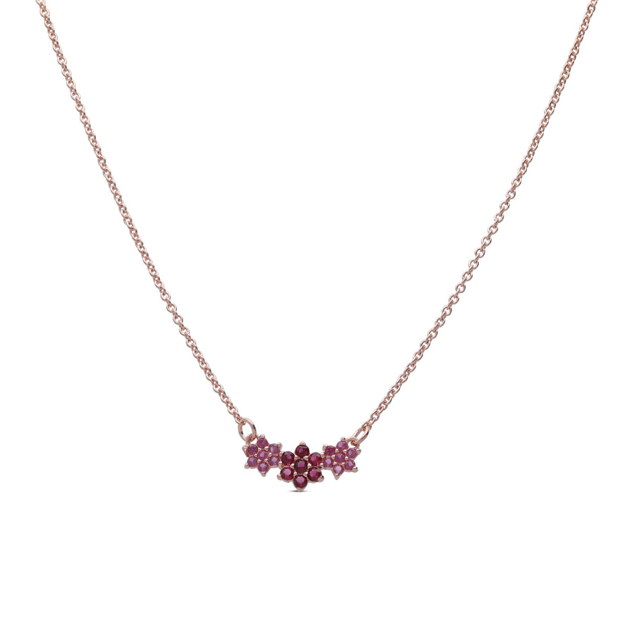 The three flower necklace is studded with ruby colored crystal stones