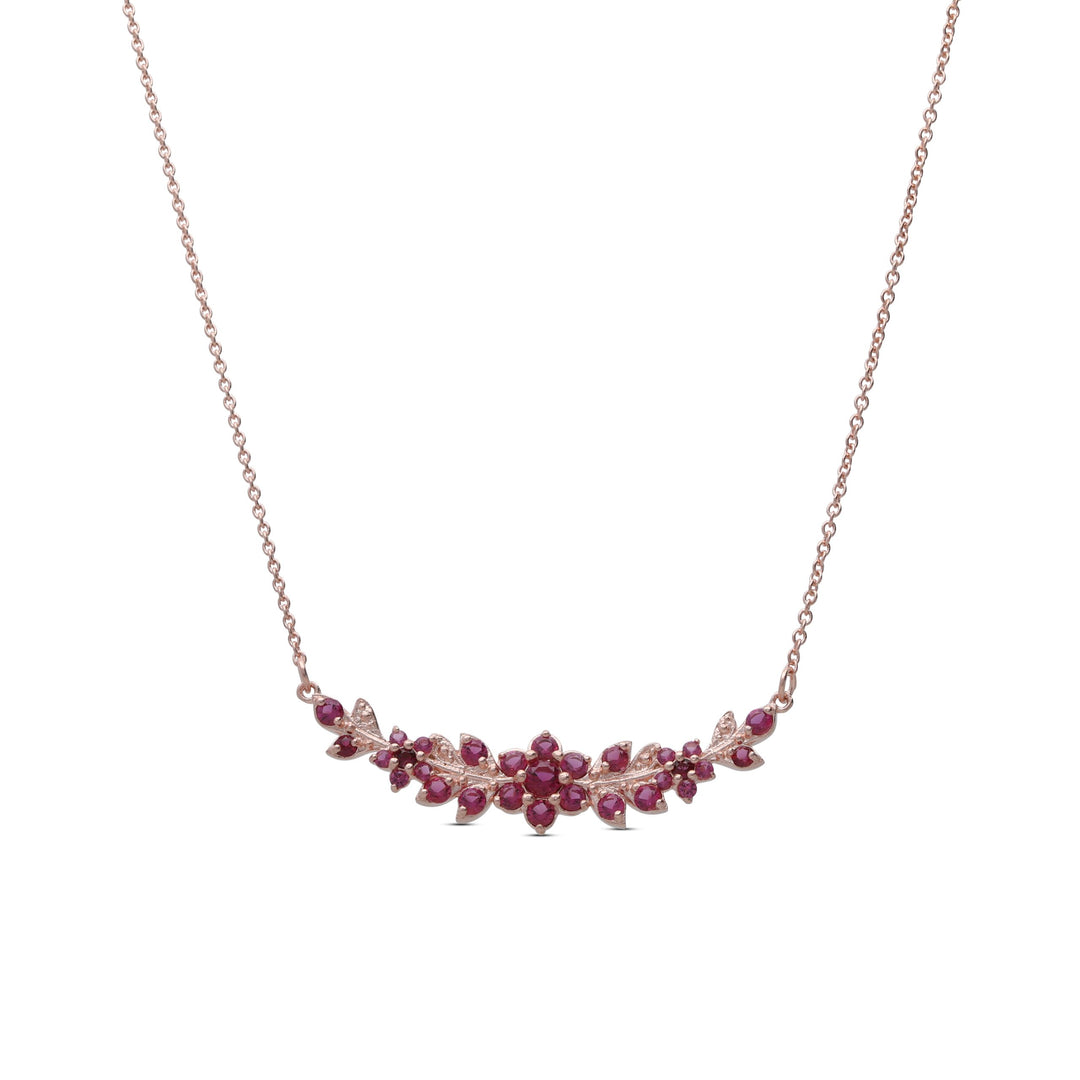 A long flowering branch necklace studded with ruby ​​colored crystal stones