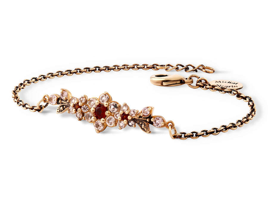 A medium flowering branch bracelet inlaid with cream garnet colored crystals