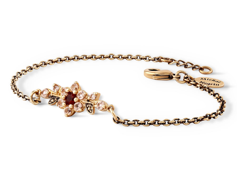 A short flowering branch bracelet studded with cream garnet colored crystals
