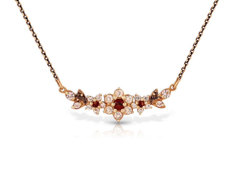A medium flowering branch necklace studded with cream garnet colored crystal stones