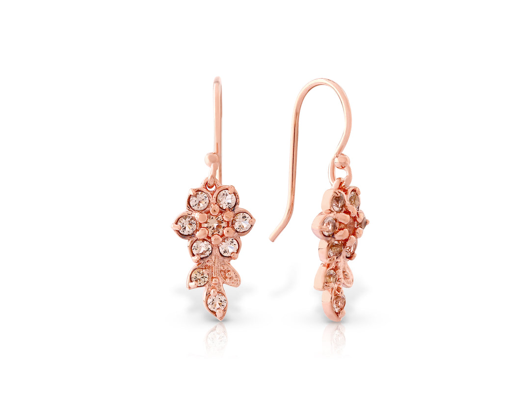 Earrings hanging from a short flowering branch in rose gold plating and champagne colored crystals