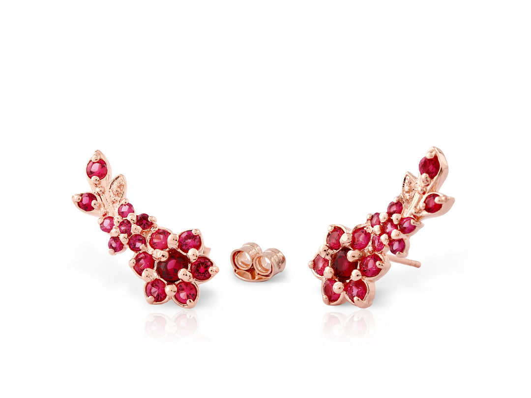 Stud earrings with the sounds of flowers are studded with ruby-colored crystal stones