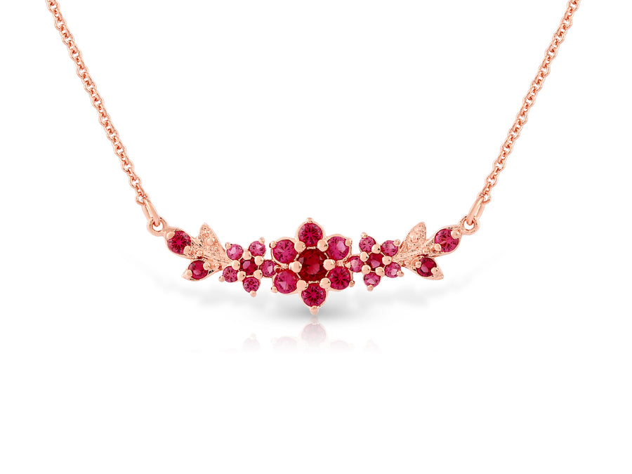 Medium flowering branch necklace studded with ruby colored crystal stones