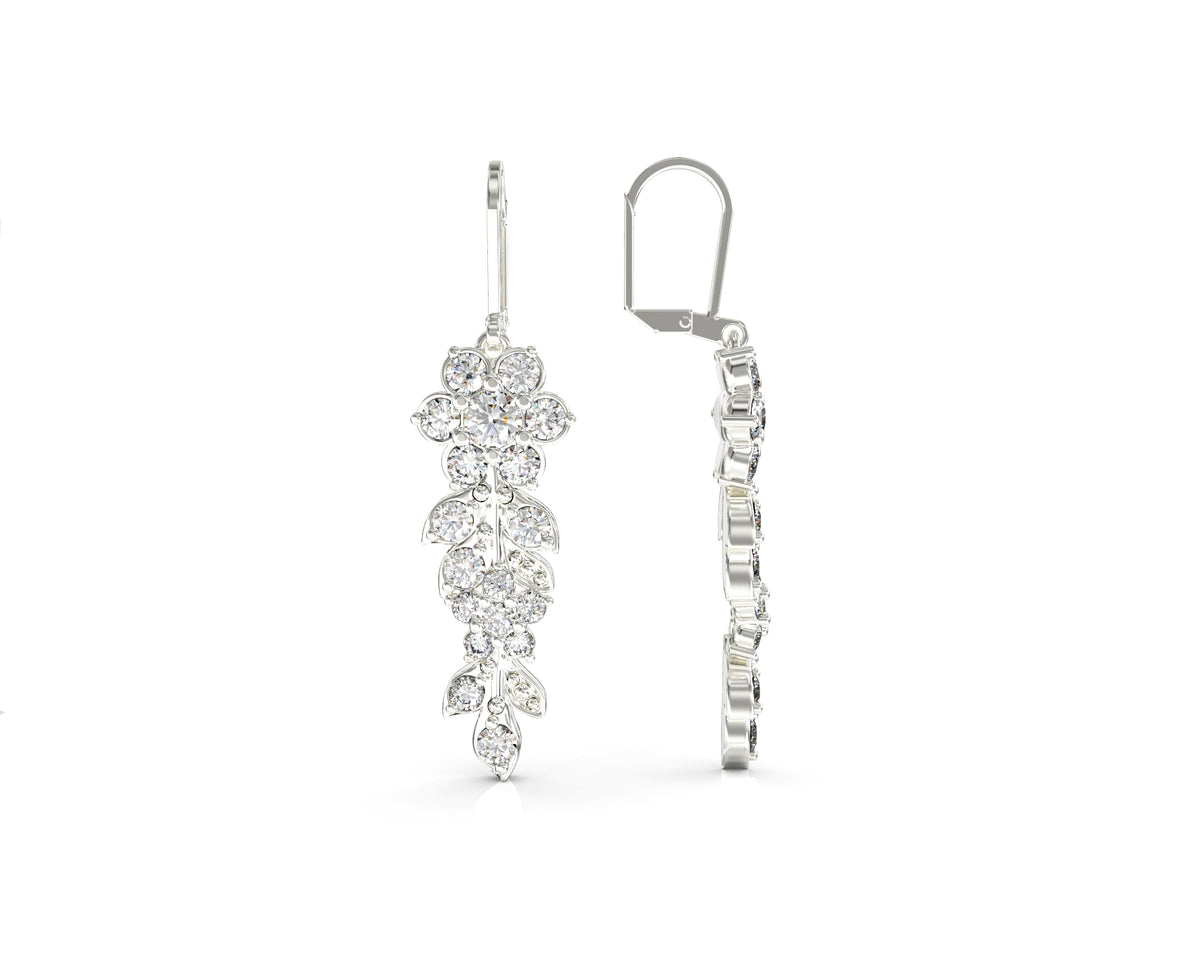 Gold earrings hang from a long flowering branch
