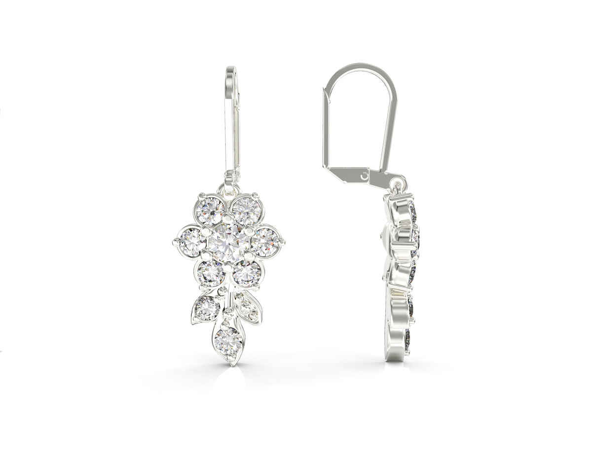 Gold earrings hang from a short flowering branch