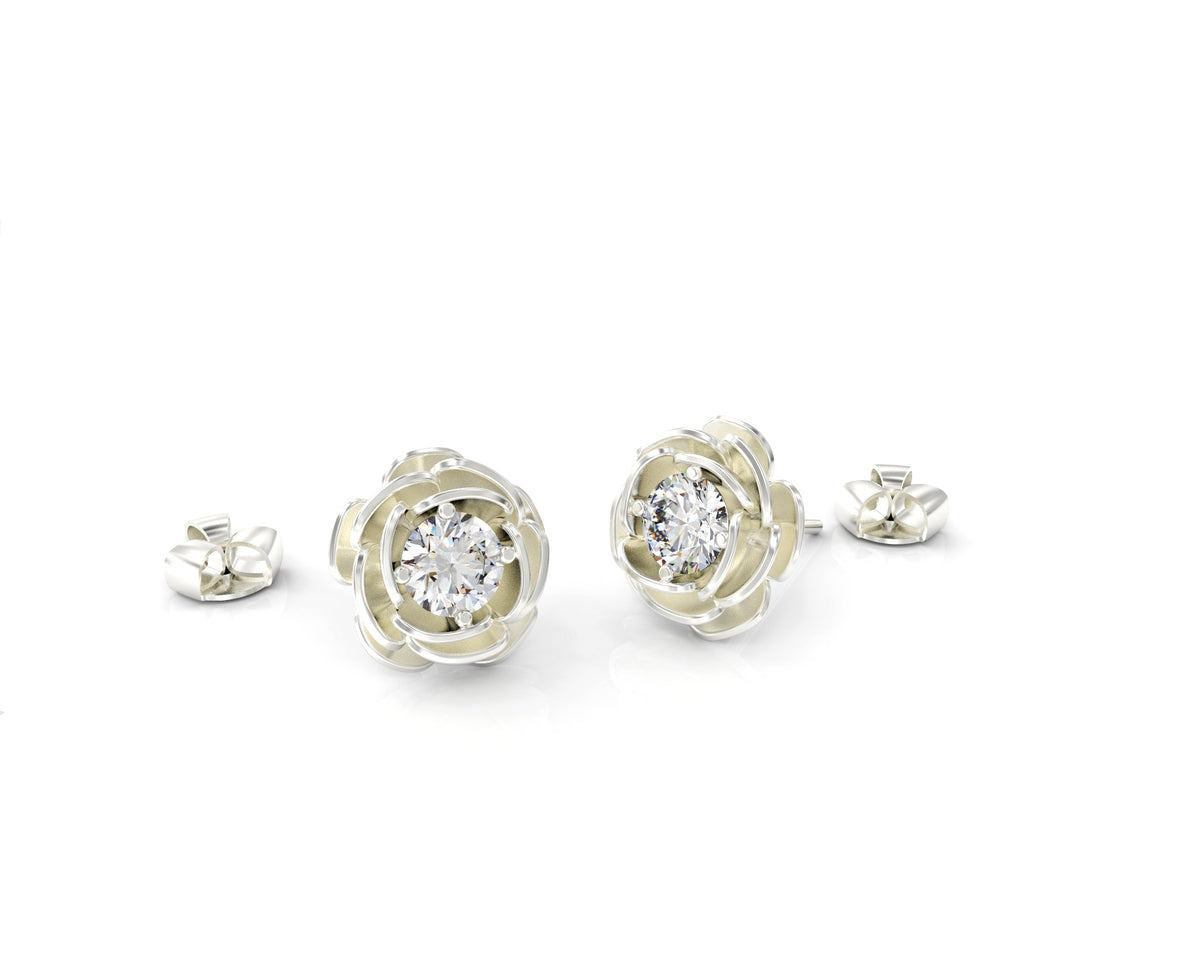 Gold earrings attached to a rose