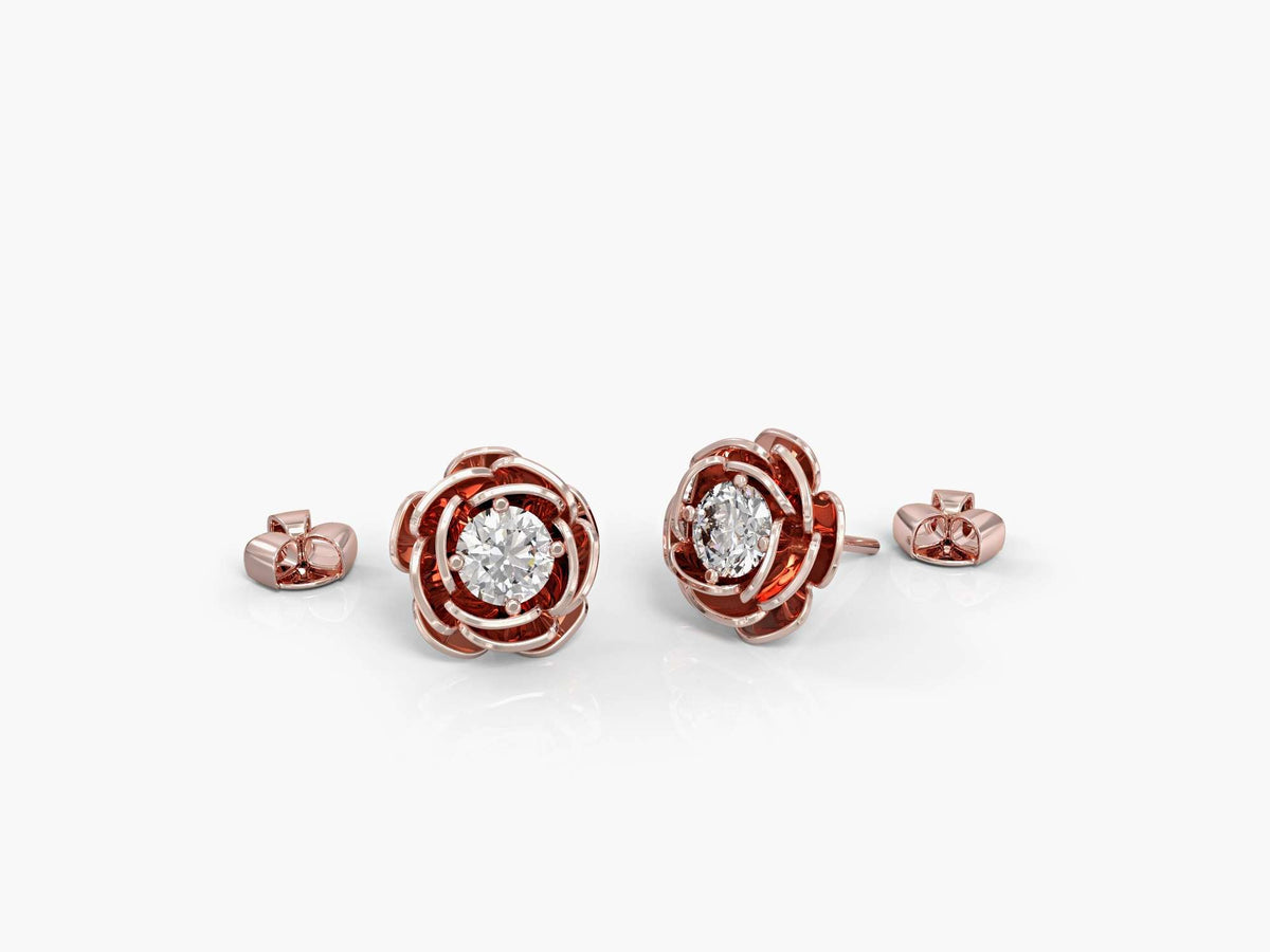 Gold earrings attached to a rose