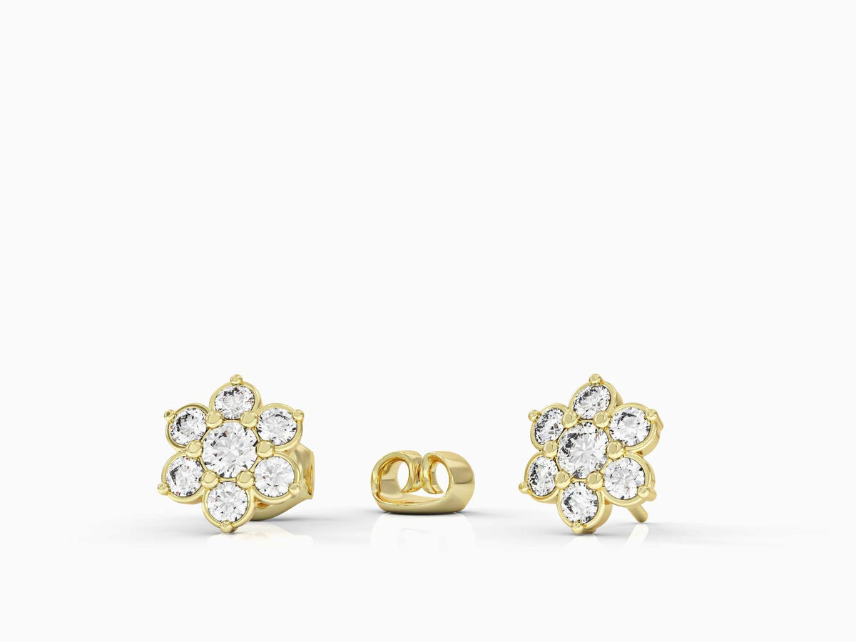 A gold earring attached to a flowering branch