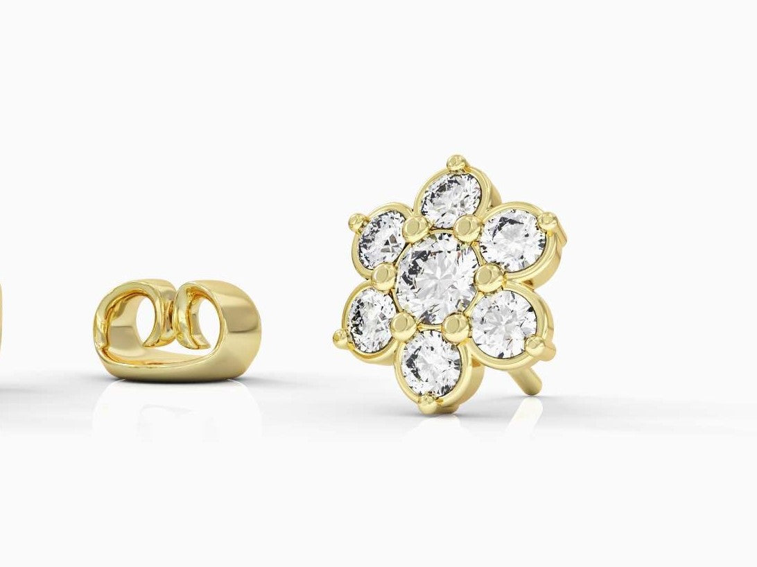 A gold earring attached to a flowering branch