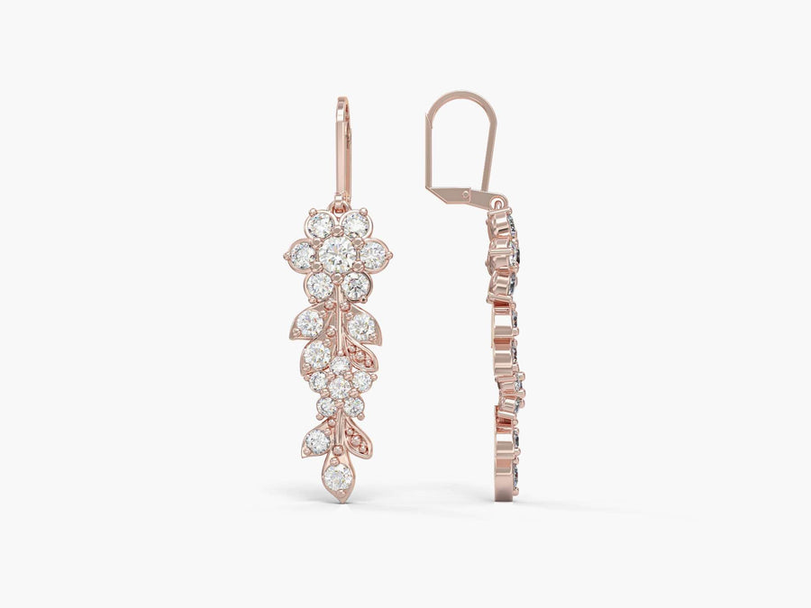 Gold earrings hang from a long flowering branch