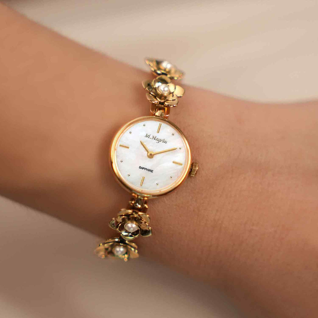 Women's wristwatch with a gold-plated pearl-studded flower bracelet design 