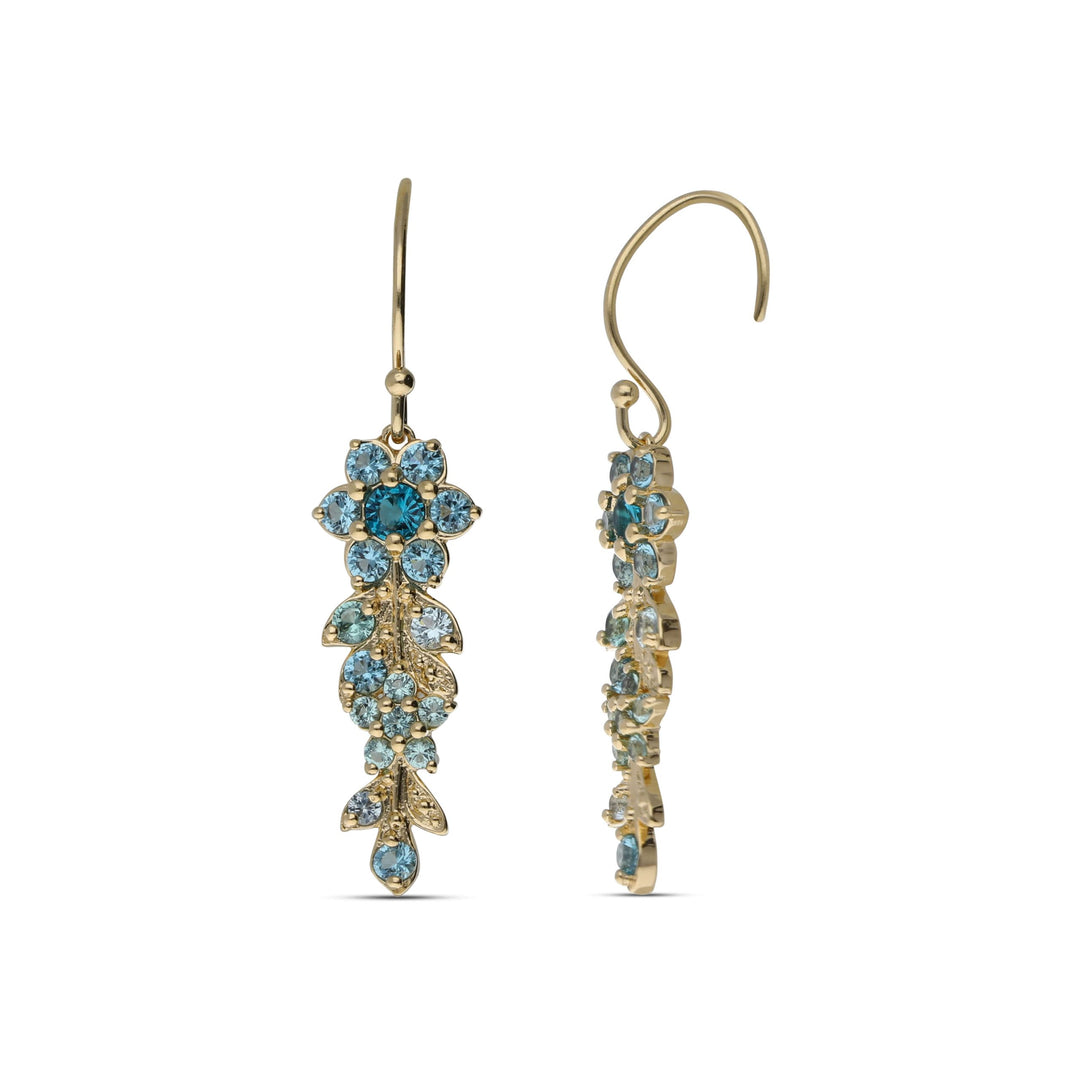 Earrings hanging from a long flowering branch studded with turquoise crystal stones