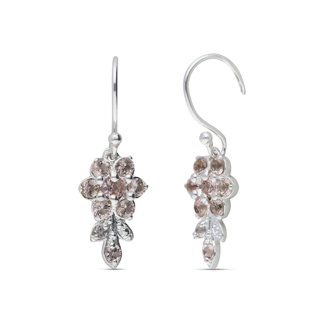Earrings hanging from a short flowering branch studded with champagne colored crystal stones