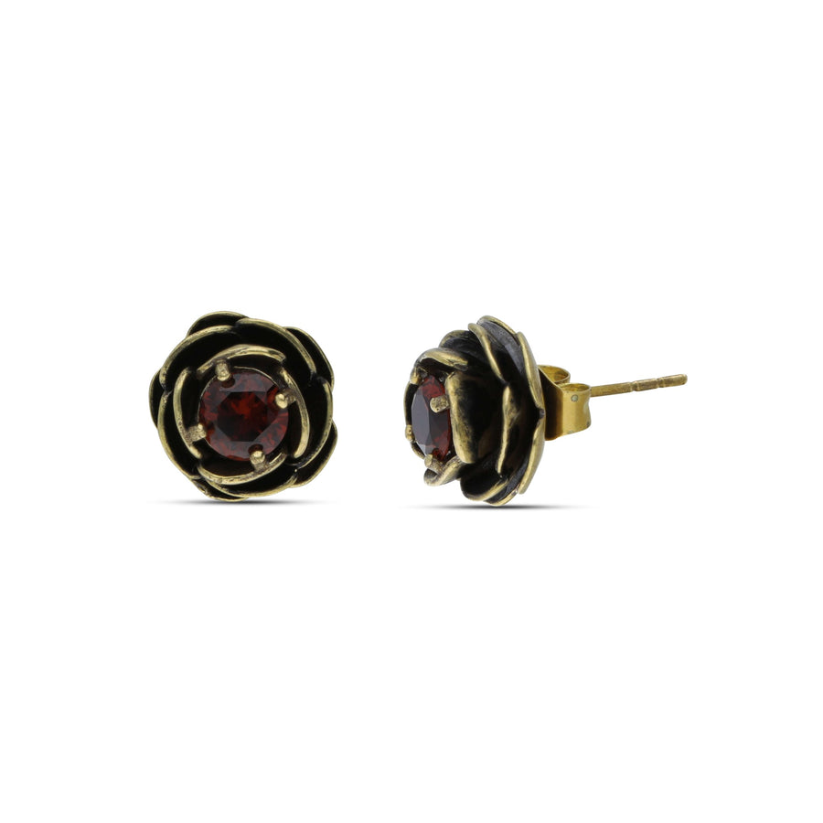 Close-up rosette earrings studded with a dark garnet crystal stone