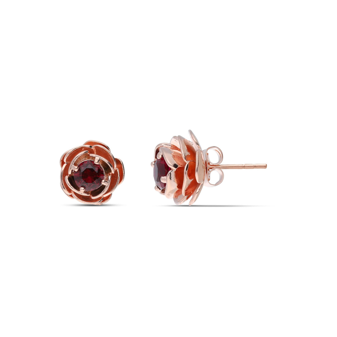 Rose earrings studded with a ruby ​​colored crystal stone