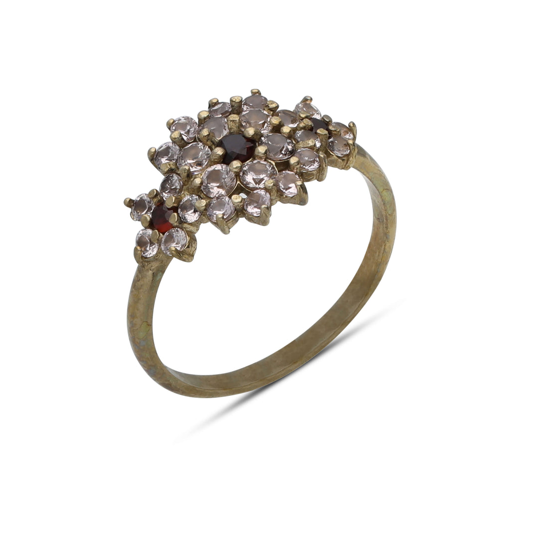 A floral rhombus ring studded with champagne colored crystal stones