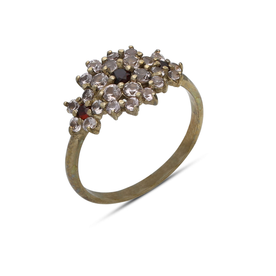 A floral rhombus ring studded with cream garnet colored crystal stones