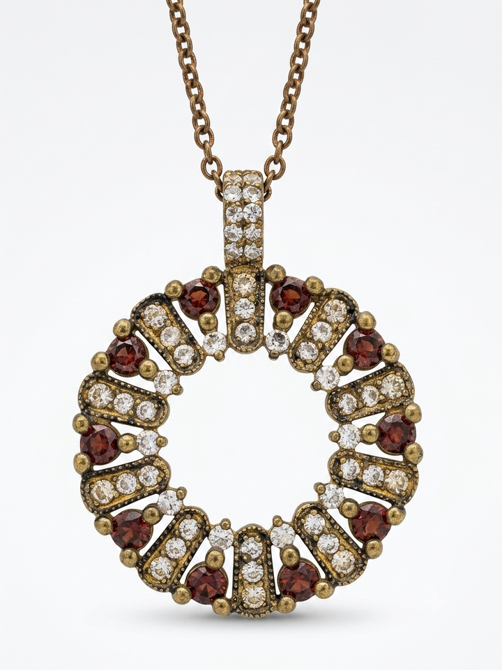 The circle of life necklace is studded with cream garnet colored crystals