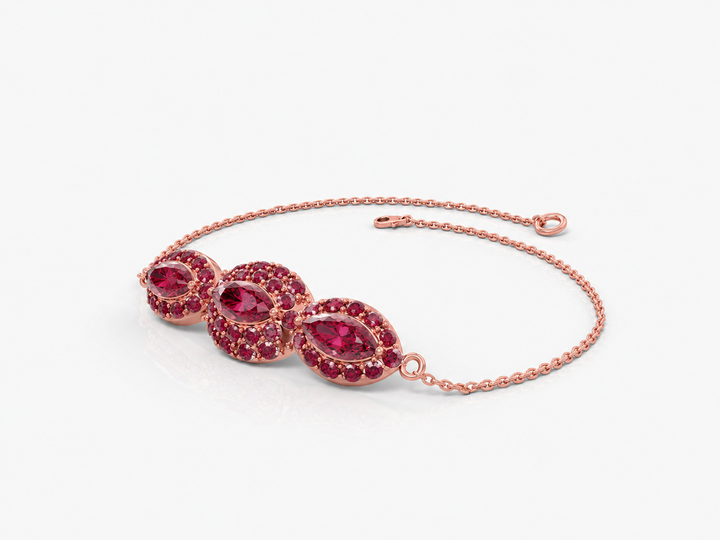 An eye bracelet in the form of a marquise inlaid with ruby colored crystal stones