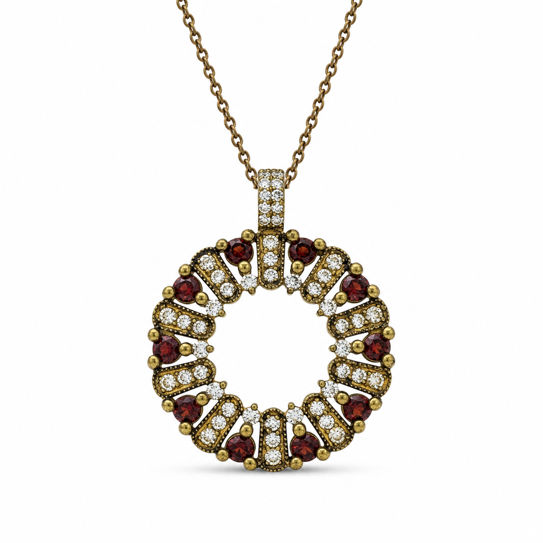 The circle of life necklace is studded with cream garnet colored crystals